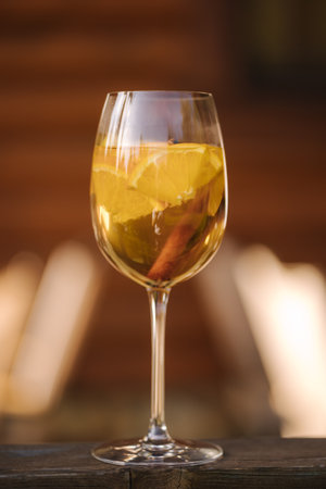 Glass of white dry wine with slice of lemon on wooden tableの写真素材