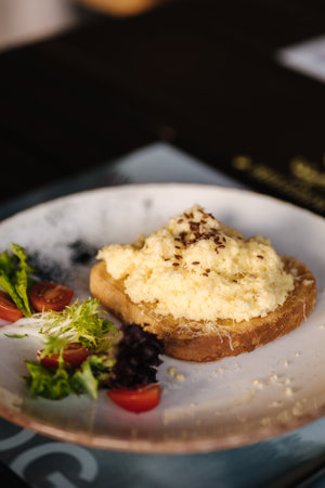 Delicious and beautiful breakfast. Toast with scramble on top, sprinkled with spices and flax seeds.の写真素材