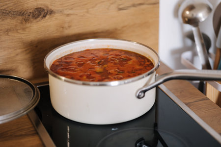 Mexican traditional dish is boiling in white pans. Home made food concept. Spicy food
