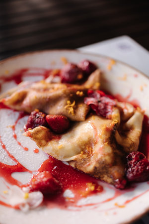 Homemade crepes, tasty thin pancakes with strawberry jamの写真素材