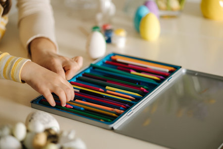 Hand of little girl choosing pencils for colouring picture. Close-upの写真素材