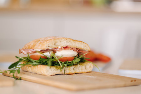 Tasty bruschetta on wooden board. Classic Italian lunch. Baguette with tomatoes, mozzarella and olive oilの写真素材