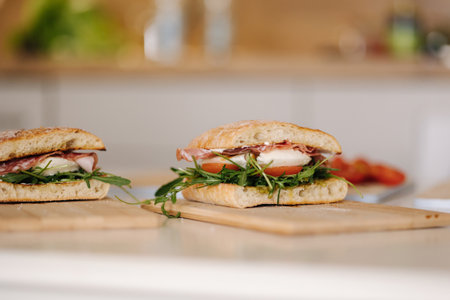 Two delicious Italian sandwich on wooden board. Healthy food conceptの写真素材