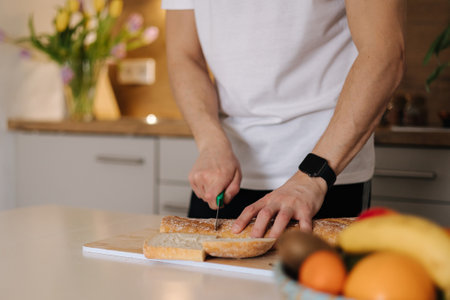 Middle selection of man sliced baguette on wooden table in kitchenの写真素材