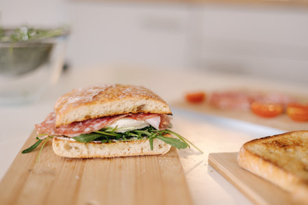 Tasty bruschetta on wooden board. Classic Italian lunch. Baguette with tomatoes, mozzarella and olive oilの写真素材
