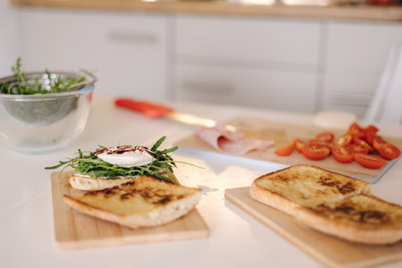 Almost finished Italian bruschetta on wooden table. Healthy food conceptの写真素材