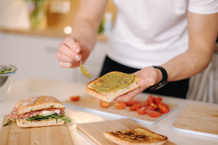 Spread pesto on roasted slice of baguette. Middle selection. Italian foodの写真素材