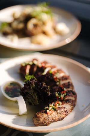 Tasty baked pork tenderloin and a side dish of potatoes on summer terrace. Outdoor dinnerの写真素材