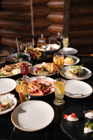 Served table with food and drinks. Restaurant on terrace.の写真素材