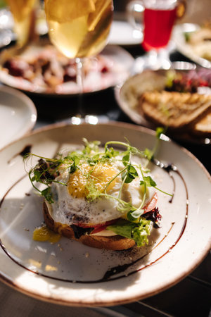 Delicious breakfast in restaurant. Toast with egg on the topの写真素材