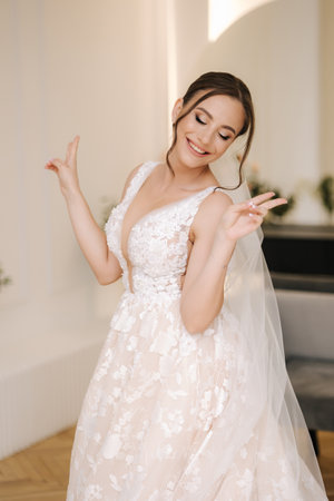 Cheerful bride smile and have fun in her bridal morning. Wedding dayの写真素材