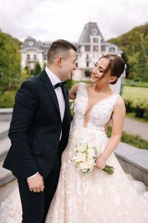 Beautiful wedding couple have fun at their wedding. Newlyweds walking outdoorsの写真素材