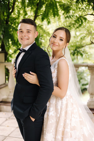 Portrait of gorgeous bride in wedding dress standing outdoors. Beautiful bride in elegant dressの写真素材