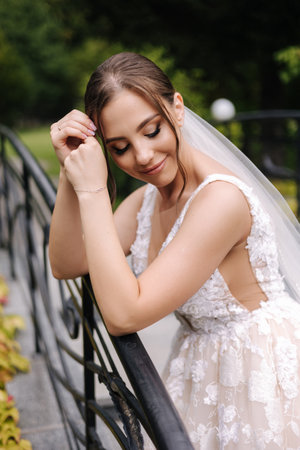 Portrait of attractive bride in gorgeous wedding dress. Elegant woman with evening makeupの写真素材