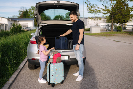 Father help daughter loading to the trunk with luggage before traveling while mom packs her luggageの写真素材