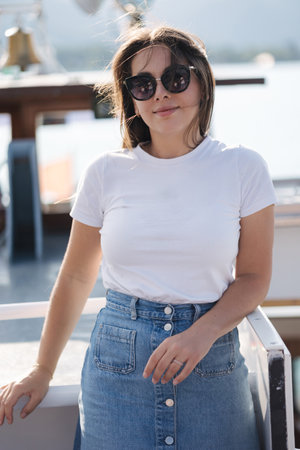 Portrait of a beautiful woman sailing on a ship along the lake. High quality photoの写真素材