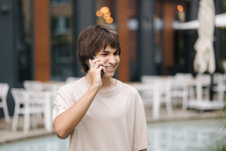 Handsome boy is calling to friends and invites to go out for a walkの写真素材