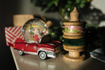 Retro toy Santa car on Christmas gifts. Snow globe with Santaの写真素材