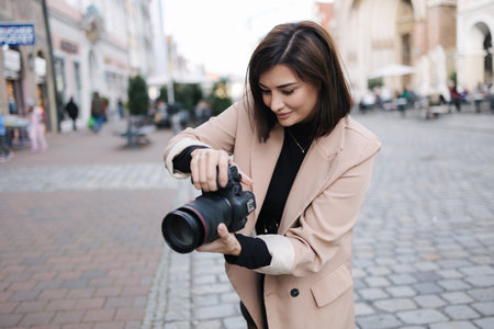 Process of female photographer making photo in the centre of the cityの写真素材