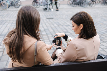 Female photographer show to client her photo on camera.の写真素材