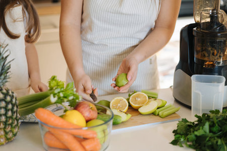 Middle selection of woman peel kiwi. Preparing for making juice in juicer. Homemade fresh and...