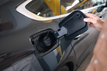Man open tank on the car for refueling. Process of starting. Gas station. First person view of...