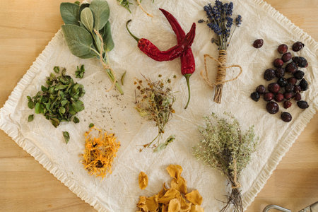 Top view of dried herbs and seasonings on linen tablecloth. Healthy homemade and natural. Red hot pepper.の写真素材
