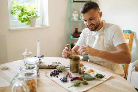Close-up of man adds dried herbs to a mortar and pestle. Homemade healthy and nutrition supplements. High quality photoの写真素材
