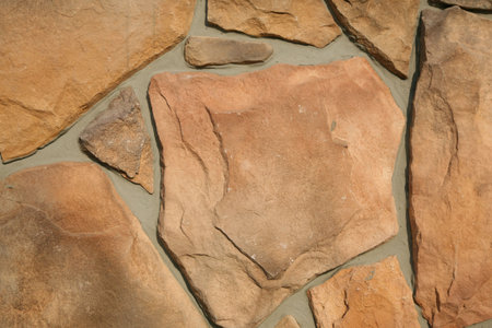 Facing of a facade of a building under a natural stone