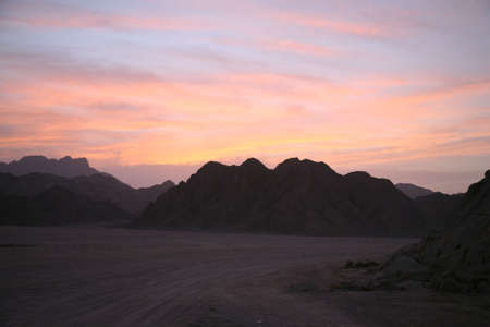 Night in desert comes almost instantly after a sunsetの写真素材