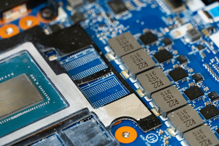 Close-up of electronic circuit board with integrated circuits, capacitors and connectors, symbolizing modern computer hardware and complex electronics design