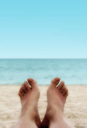 Sandy Woman Feet on a Tropical Beachの写真素材
