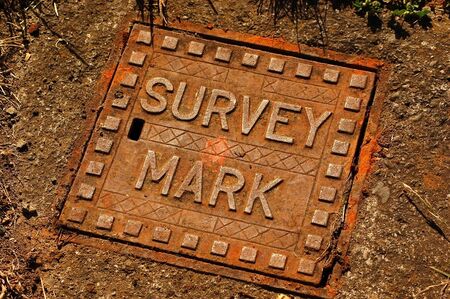 Cast iron cover for surveyor's benchmarkの写真素材
