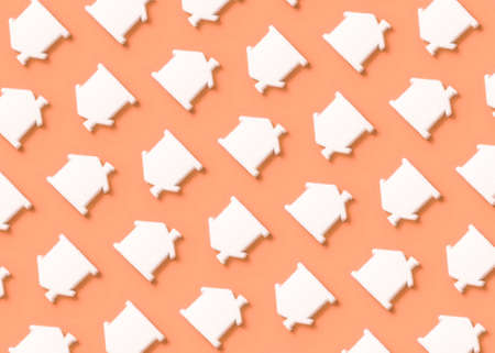 Minimal composition pattern background of white house symbol on pastel peach background. Construction and financing concept.の写真素材