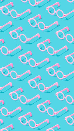 Minimal vertical pattern with pink round glasses frame on serenity pastel blue background.の写真素材