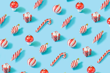 Trendy composition pattern with colorful Christmas decorations on bright blue background.  Happy holidays wallpaper.の写真素材