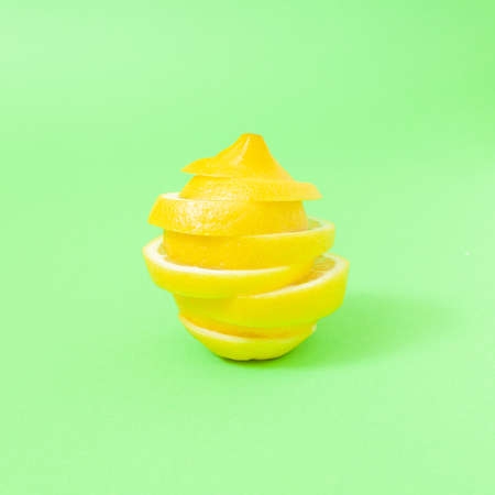Minimal composition with bunch of lemon slices on pastel  green background.の写真素材