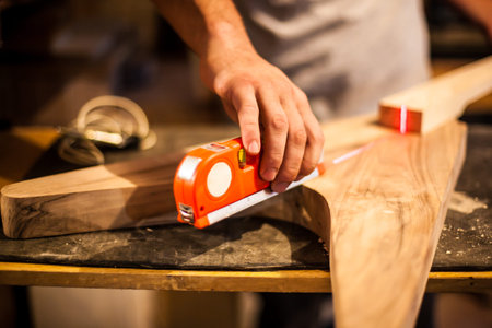Man is making gutar using laser intrument.