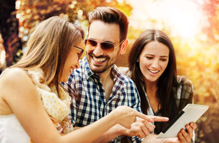Group of young people having fun in the park.の写真素材