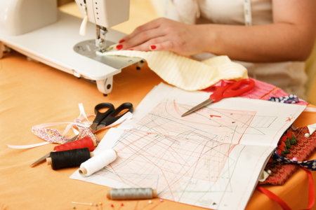 Young woman is sewing at home.