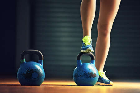 Fitness woman training by kettlebell.の写真素材