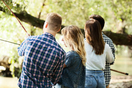 Group of young friends fishing.の写真素材