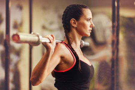 Young fit woman is training in gym.