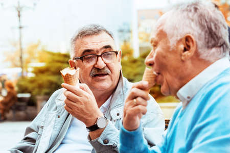 Senior friends enjoying city early in the morning.の写真素材