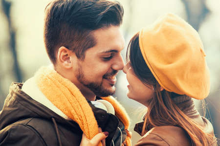 Young and attractive couple enjoying fall in the park.の写真素材