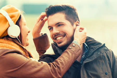 Young and attractive couple enjoying fall in the park.の写真素材
