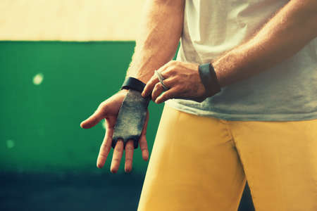 Young man is preparing hands for pick-up weight.の写真素材