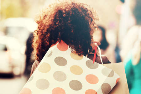 Woman in shopping. Selective focus on first bag.の写真素材