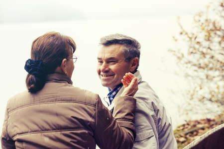 Senior couple enjoying fall  in the forest.の写真素材