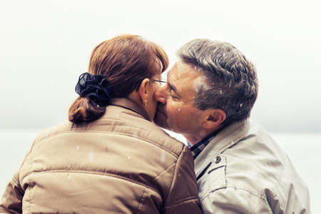 Senior couple enjoying snowing day.の写真素材